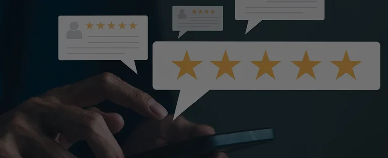 Close-up of a hand holding a smartphone with multiple five-star rating icons and review bubbles.