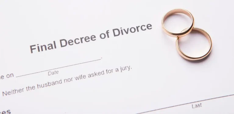 Final Decree of Divorce document with two gold wedding rings placed on the paper.