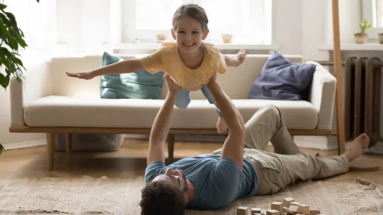 Father playing with daughter after child custody mediation