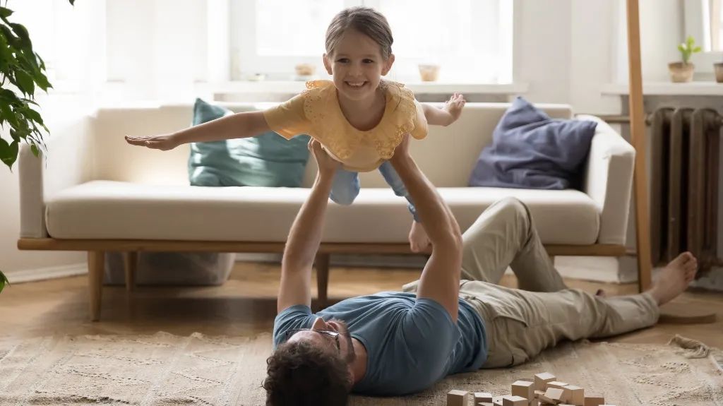 Father playing with daughter after child custody mediation